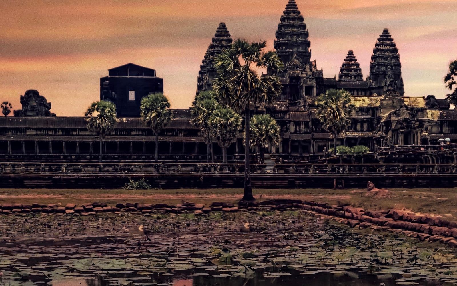 Angkor Wat temple in Cambodia at sunset, reflected in the water