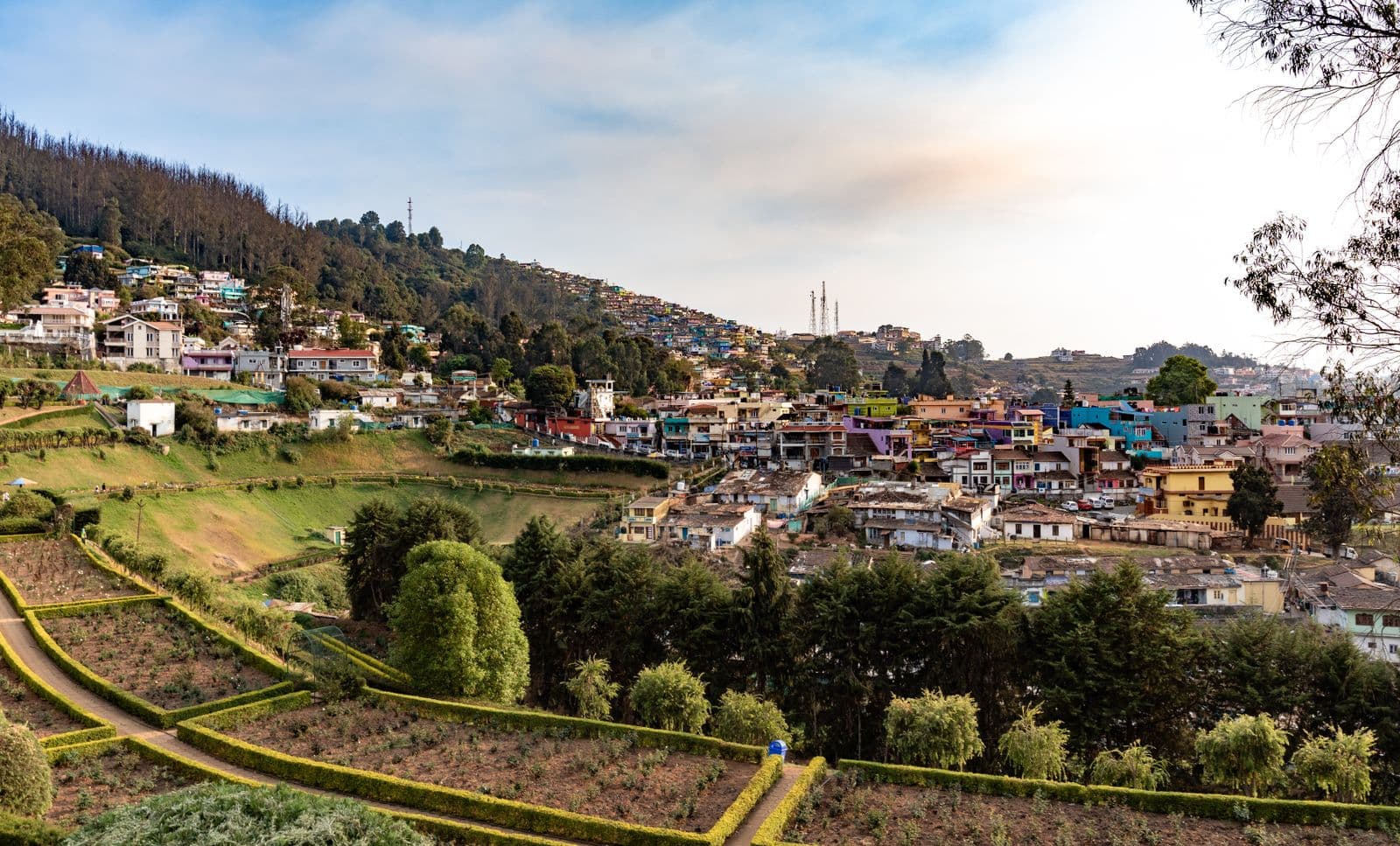Ooty town spread across the green Nilgiri hills under evening light