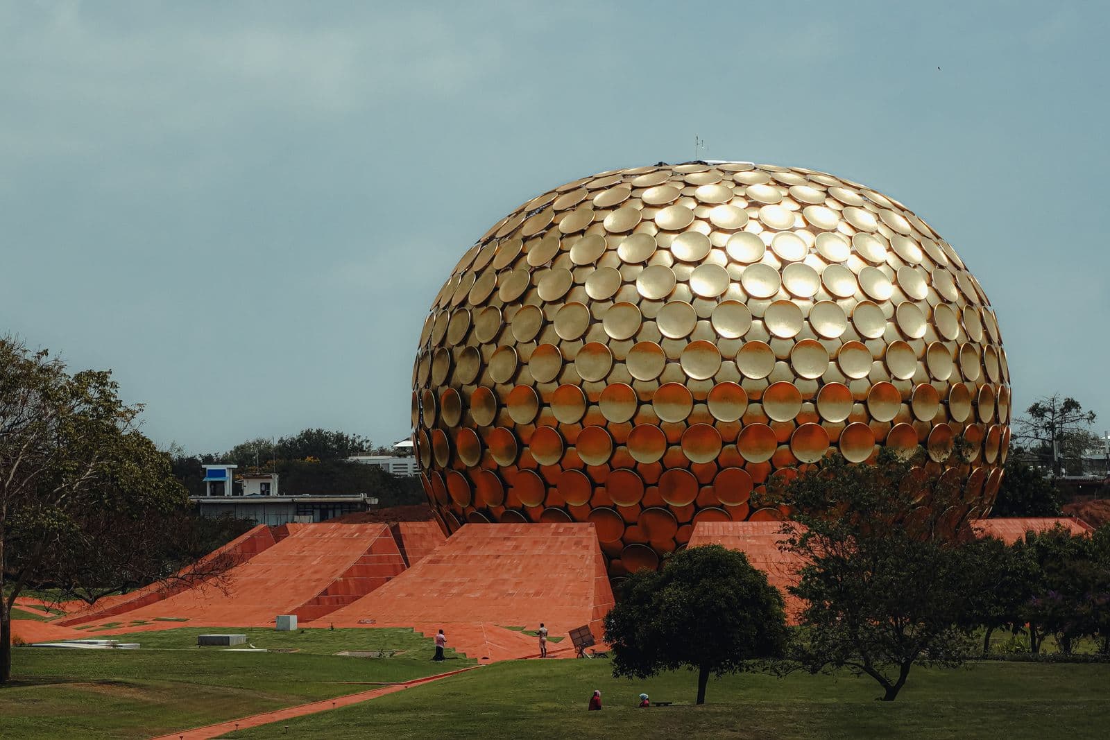 The golden sphere of the Matrimandir at Auroville under a clear sky