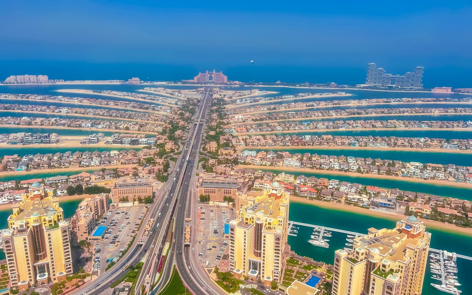 Aerial view down the trunk of Palm Jumeirah with villas along the fronds