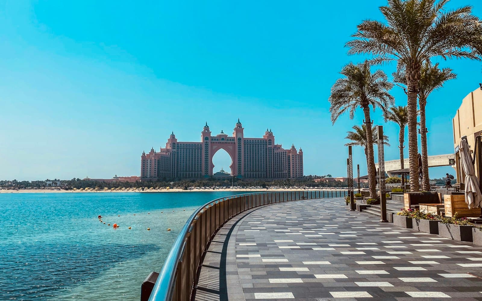 Atlantis The Palm across turquoise water, seen from the palm-lined boardwalk