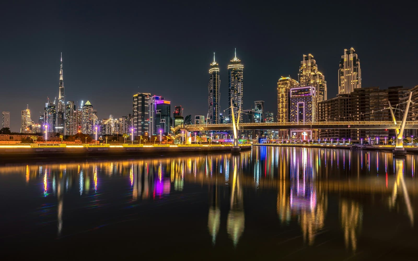 Business Bay towers reflected in the Dubai Water Canal at night