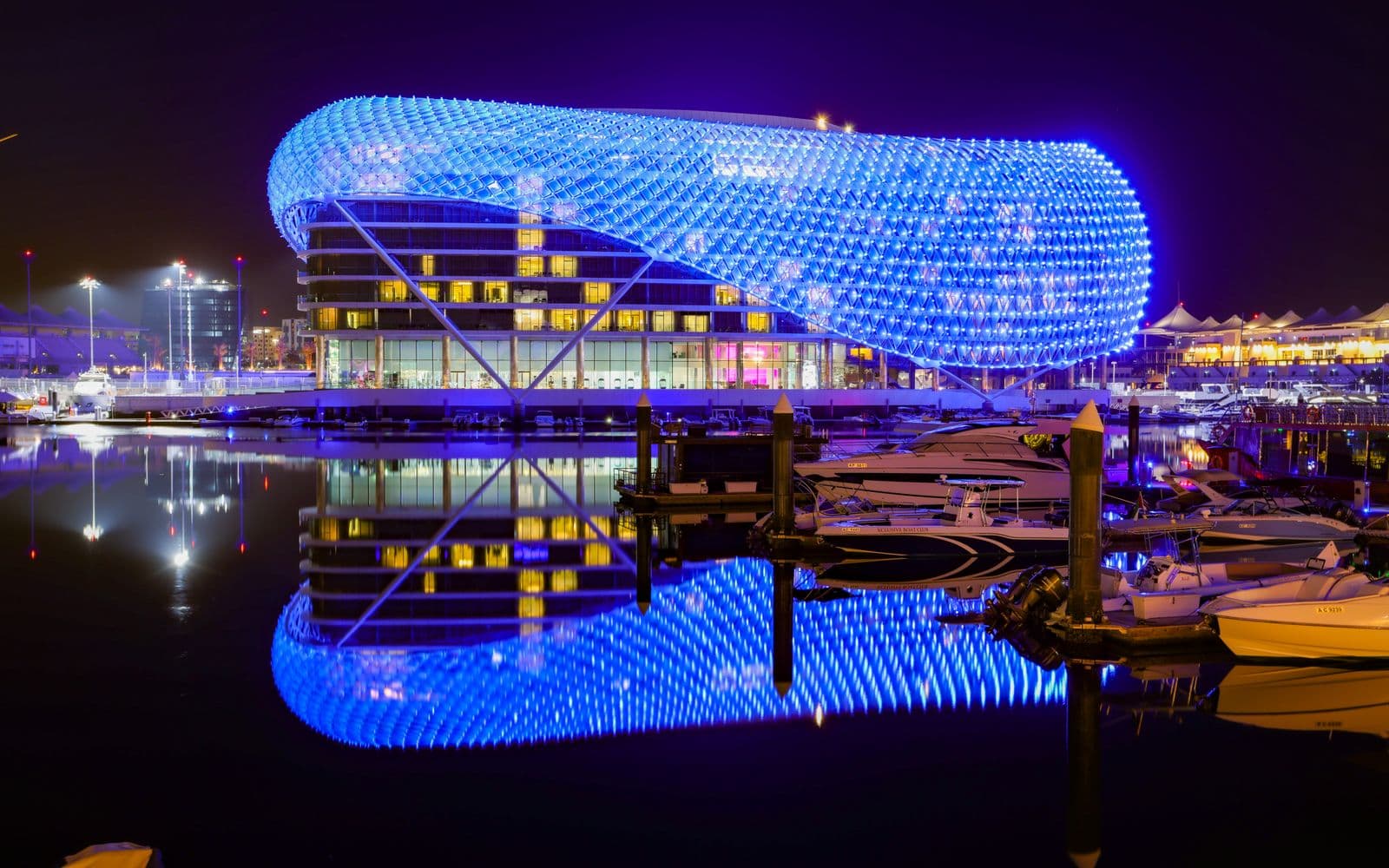 The lit grid-shell hotel over Yas Marina in Abu Dhabi at night