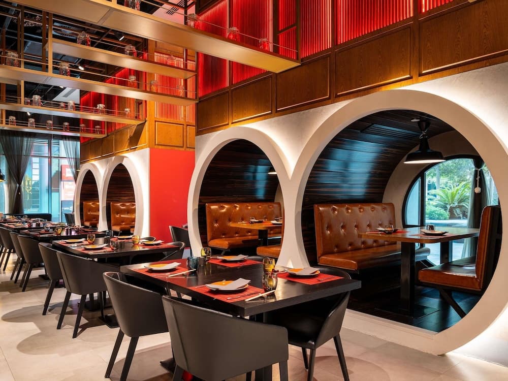 Restaurant with arched booths at ibis One Central, Dubai