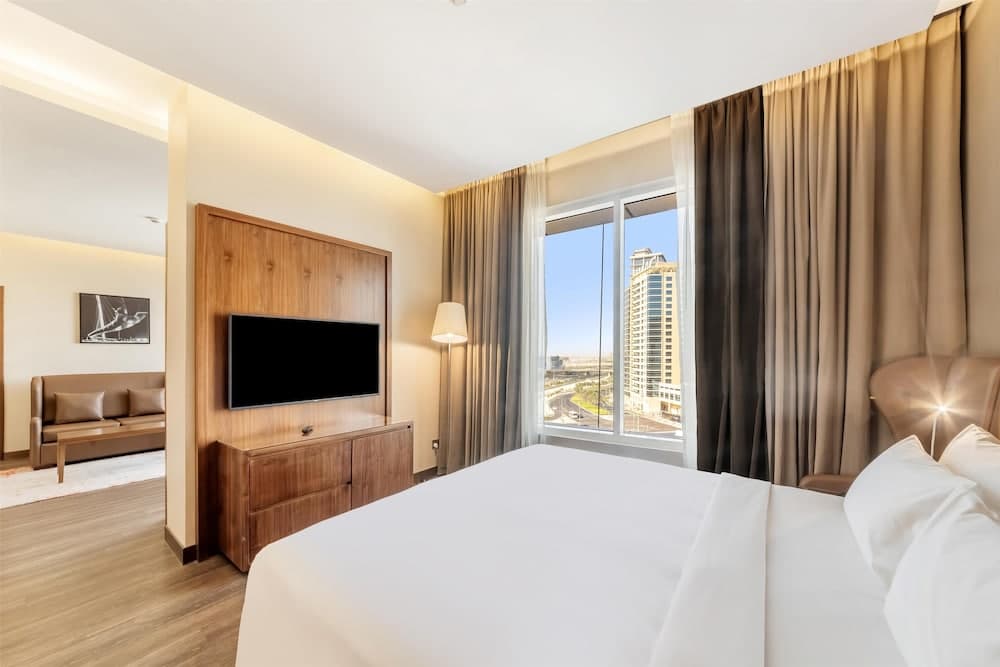 Guest room with a window view at Radisson Blu Hotel, Dubai Canal View
