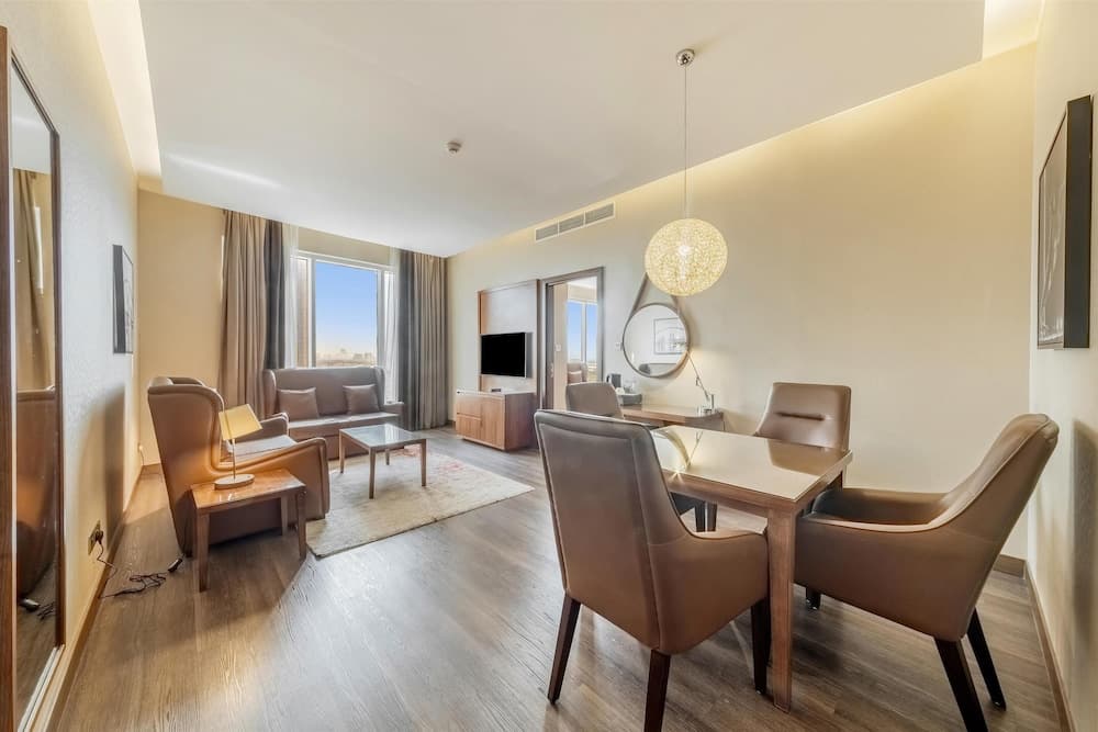 Guest room with a sofa at Radisson Blu Hotel, Dubai Canal View