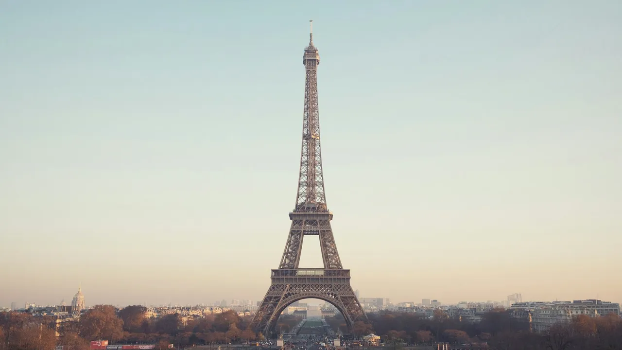 Eiffel Tower rising above Paris rooftops