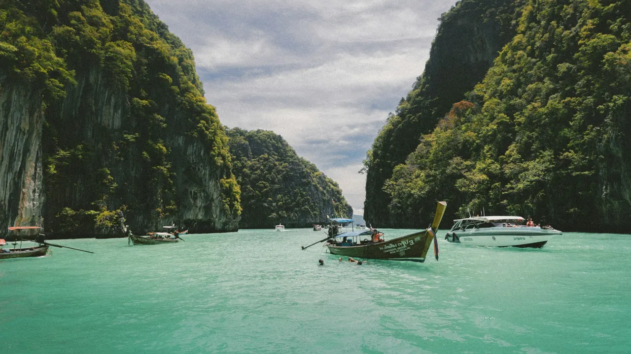 Longtail boat between limestone cliffs in Thailand